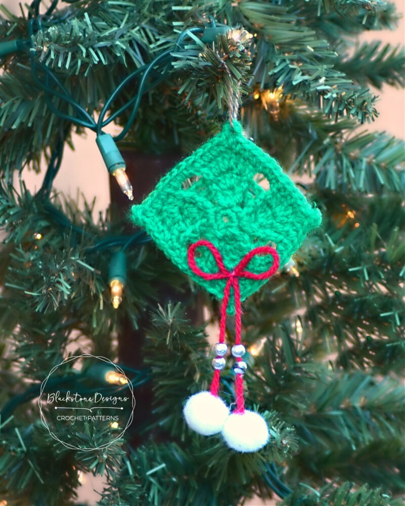 Paragon Square Ornament Crochet Pattern made from a granny square, beads, and pom poms.