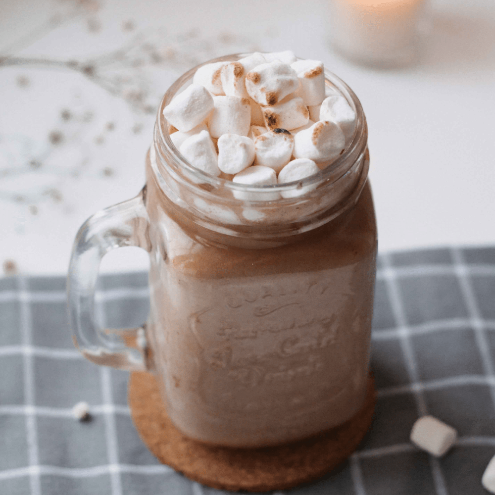 hot cocoa with marshmallows in mason jar cup