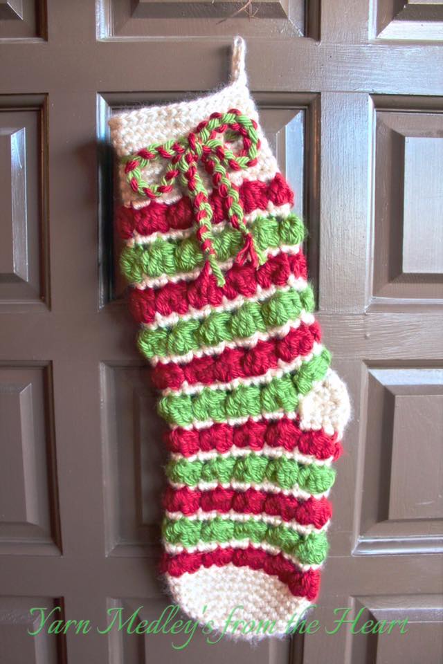 Yuletide Christmas Stocking Crochet Pattern shown in red, bright green, and cream