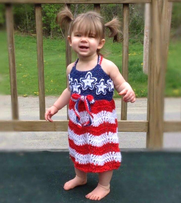 Stars and Stripes Crochet Sundress for Babies with a solid blue bodice, red and white striped skirt, white stars on bodice