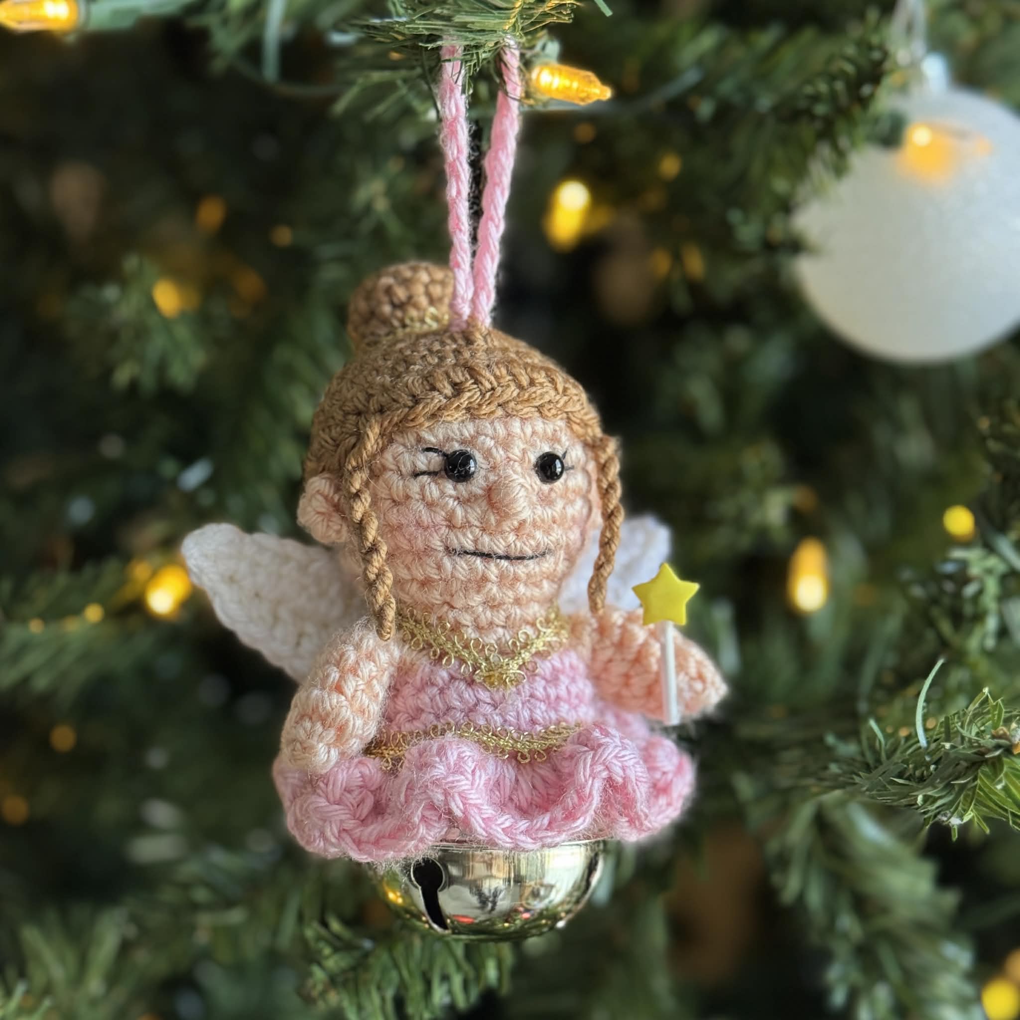 Crochet Sugar Plum Fairy Ornament in pink dress with star wand on jingle bell