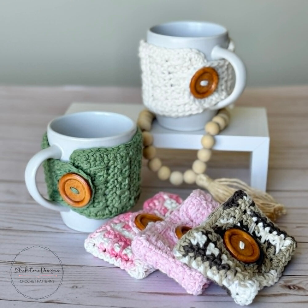 Set of crochet mug cozies in spring colors displayed with coffee mugs and wooden beads