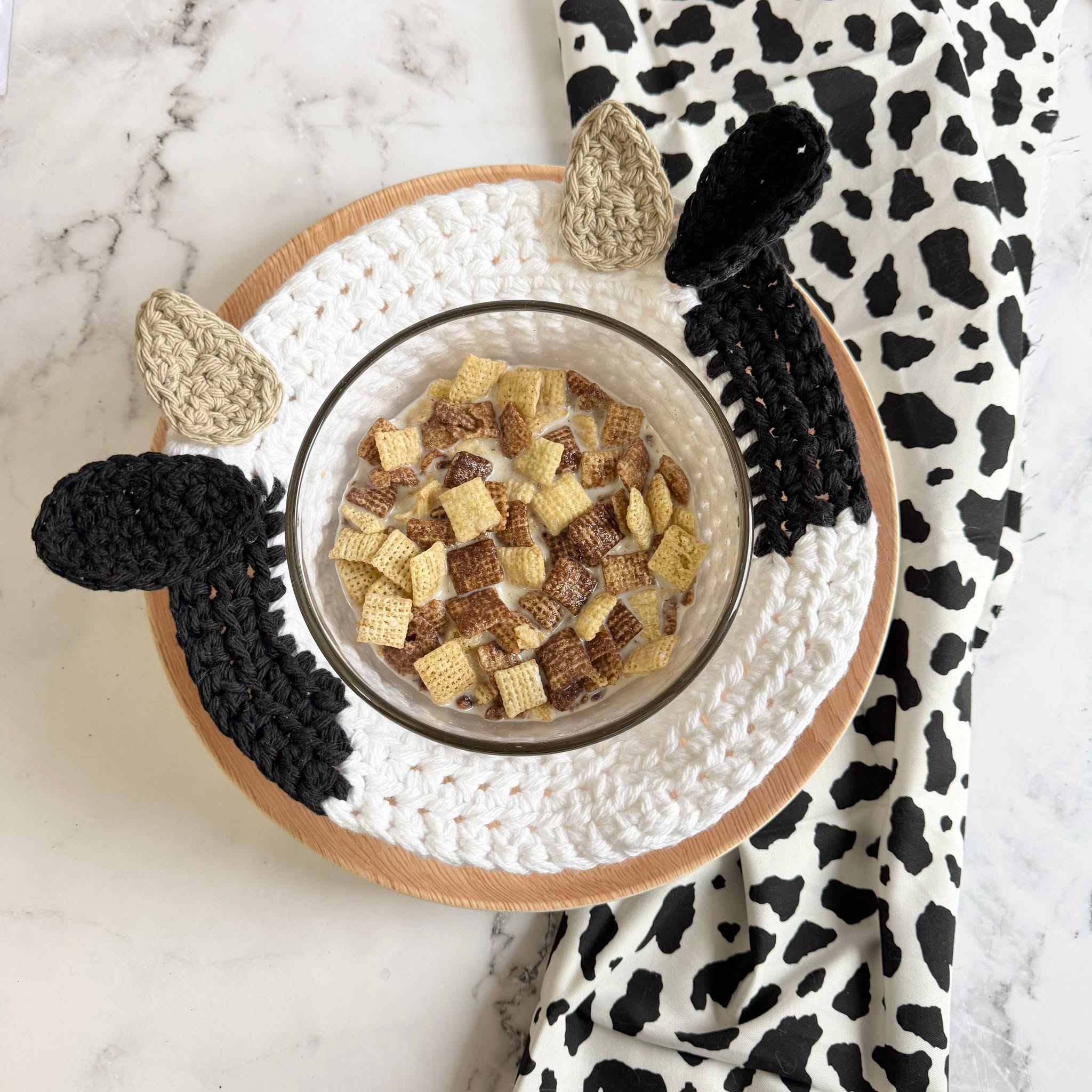 Crochet cow soup bowl cozy made with black and white cotton yarn
